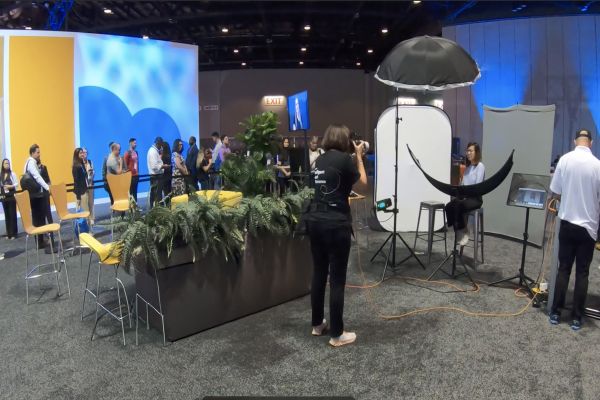 Trade show headshot experience with on-site photography studio and attendees at a convention