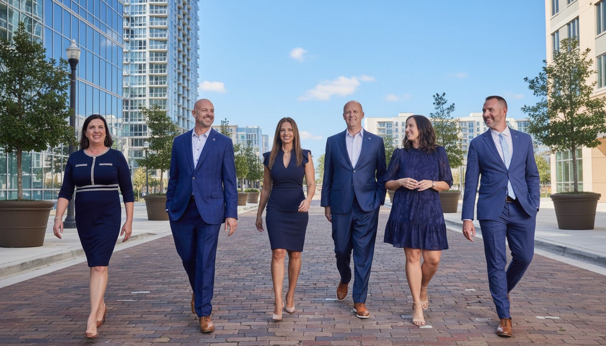 Professional business team walking confidently in a downtown environment, captured by Dana Niemeier Photography. Modern corporate branding and executive portrait imagery for websites and marketing.